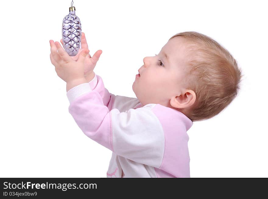 The child lasts hands to a fur-tree toy. The child lasts hands to a fur-tree toy