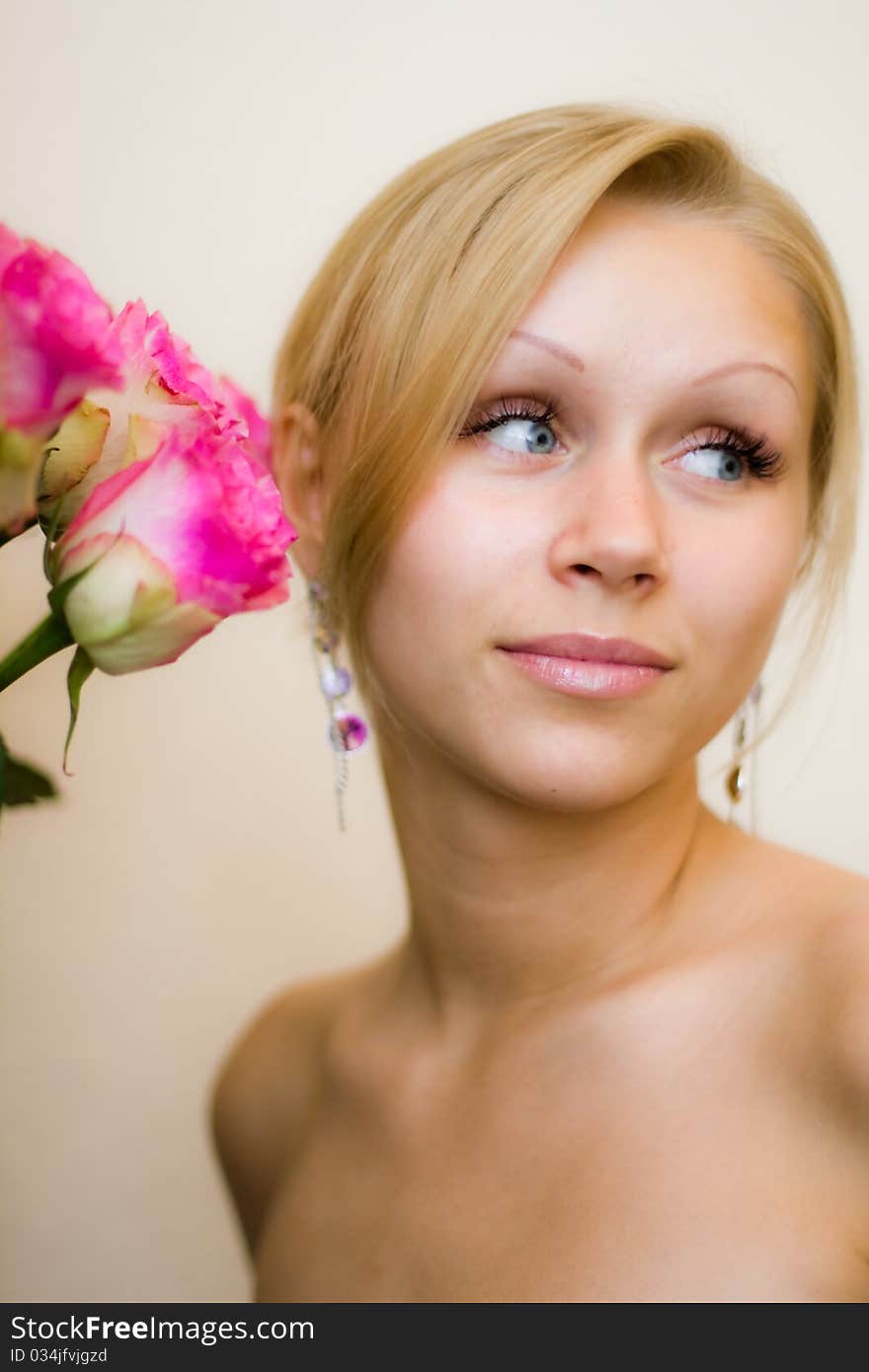 Girl sniffing beautiful flower - pink roses. Girl sniffing beautiful flower - pink roses