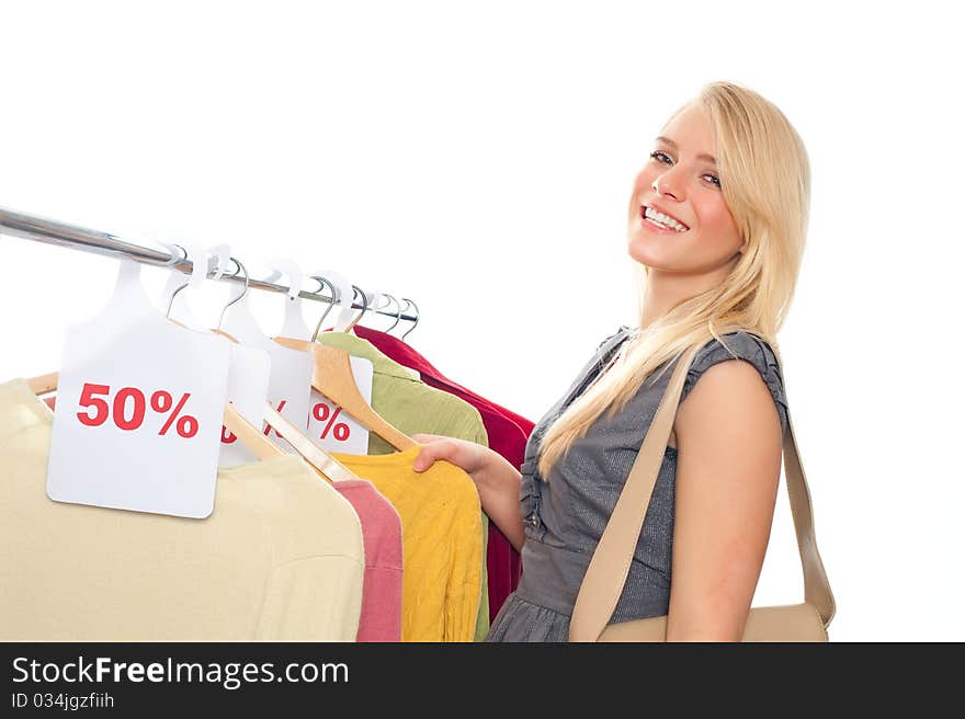 Young happy woman in clothes store on a white background