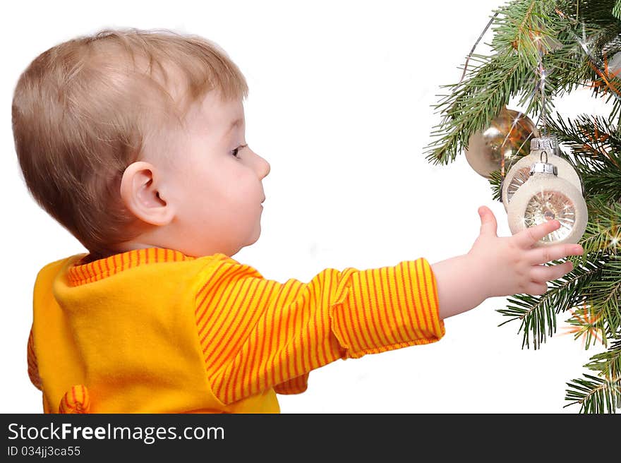 The child lasts hands to a fur-tree toy. The child lasts hands to a fur-tree toy