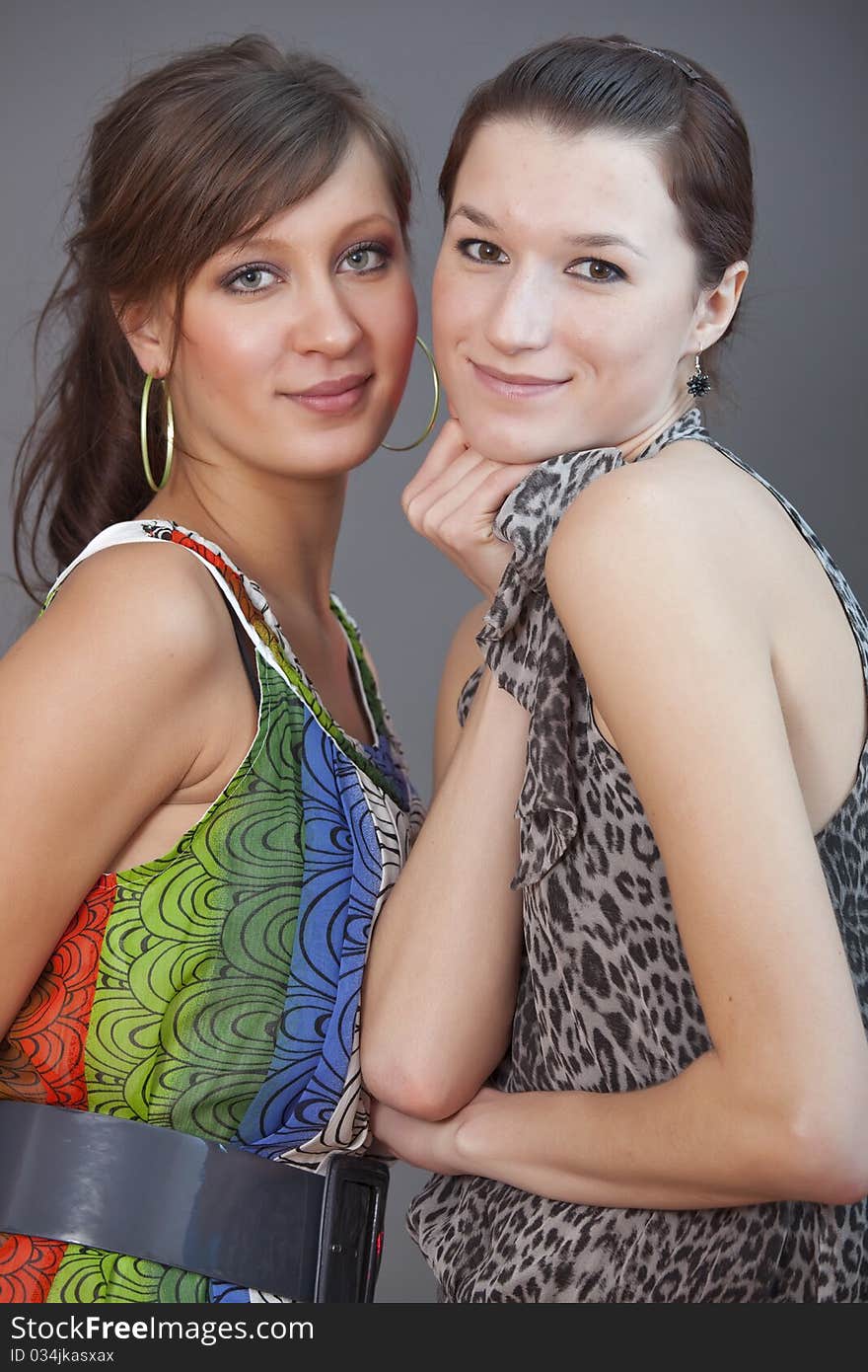 Portrait of happy female friends over grey background. Portrait of happy female friends over grey background