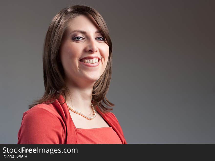 Portrait of a young pretty woman wearing a red top. Portrait of a young pretty woman wearing a red top