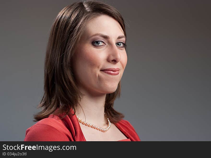 Portrait of a young pretty woman wearing a red top. Portrait of a young pretty woman wearing a red top