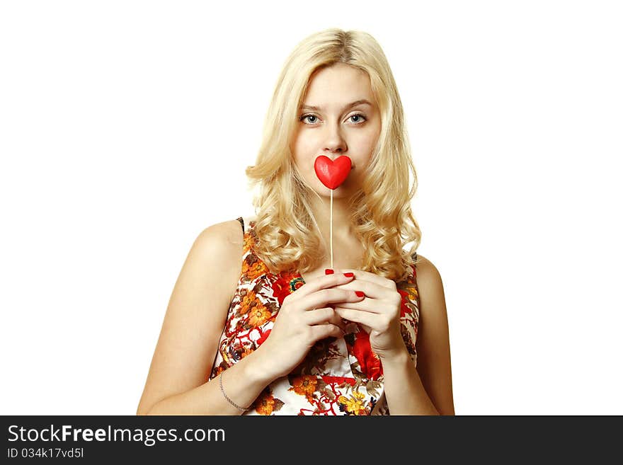 Close-up of a beautiful young woman with a red heart. Isolated on a white background. Close-up of a beautiful young woman with a red heart. Isolated on a white background