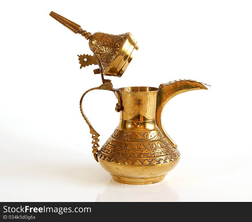 Copper jug with a traditional Arabic ornaments on a white background