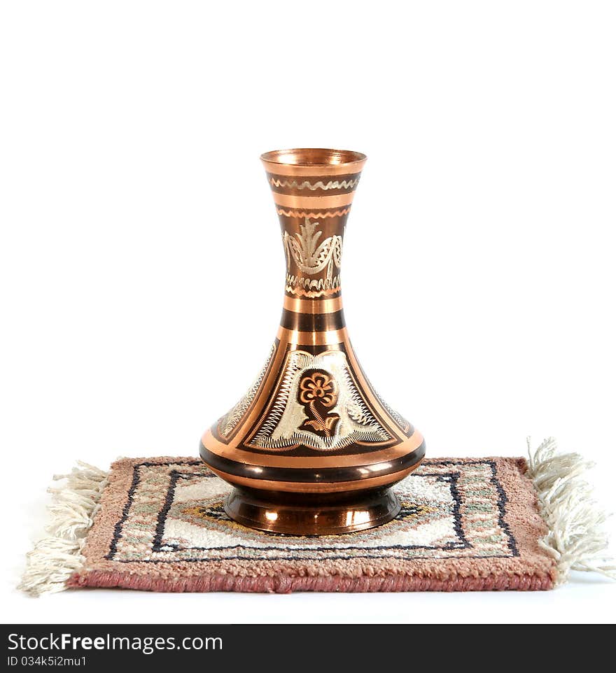 Copper jug with a traditional Arabic ornaments on a white background