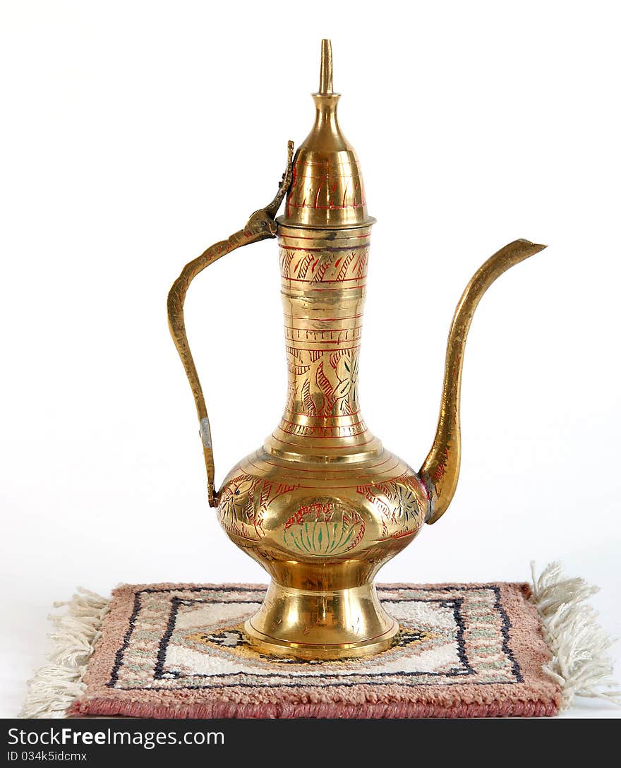 Copper jug with a traditional Arabic ornaments on a white background