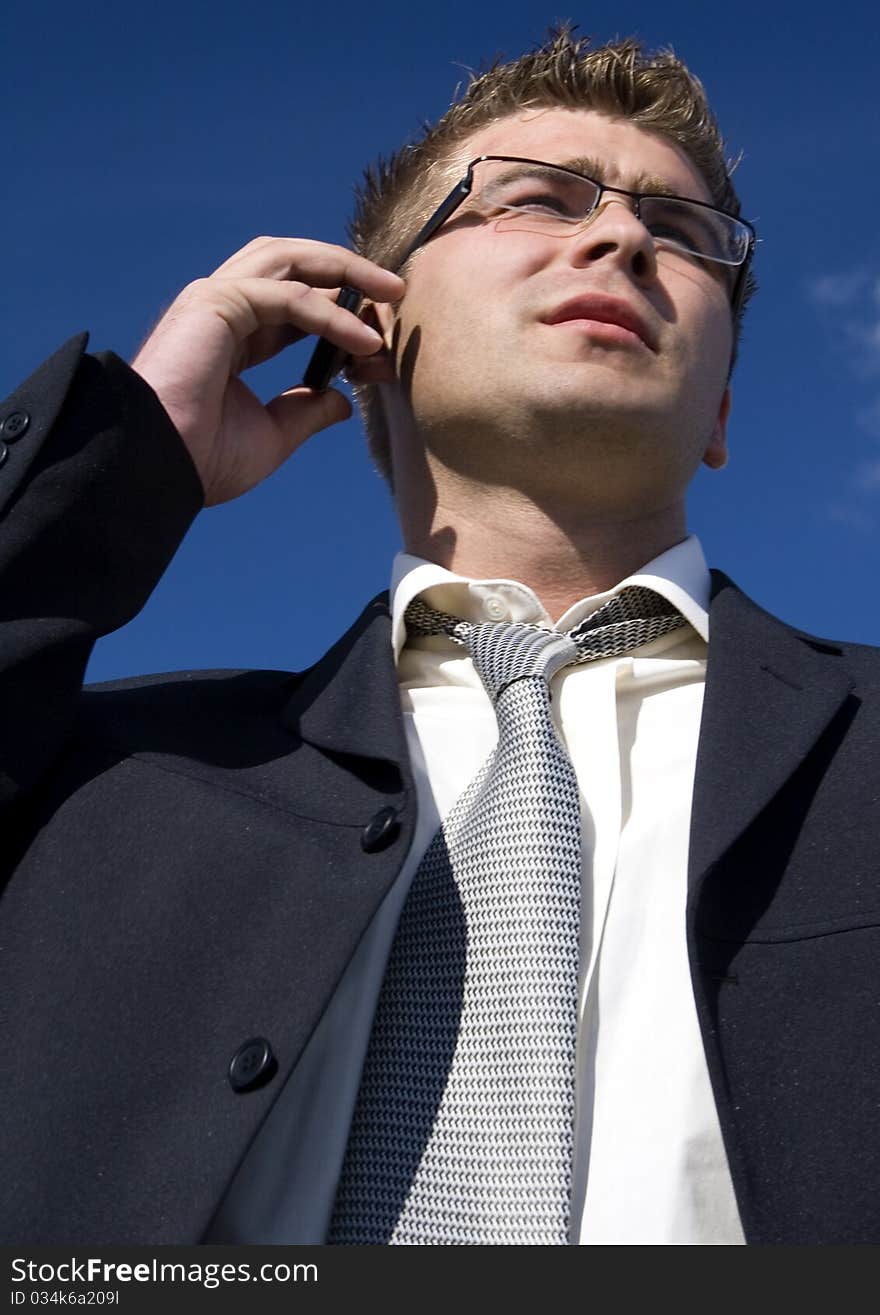 A businessman dressed in a smart suit standing on grass