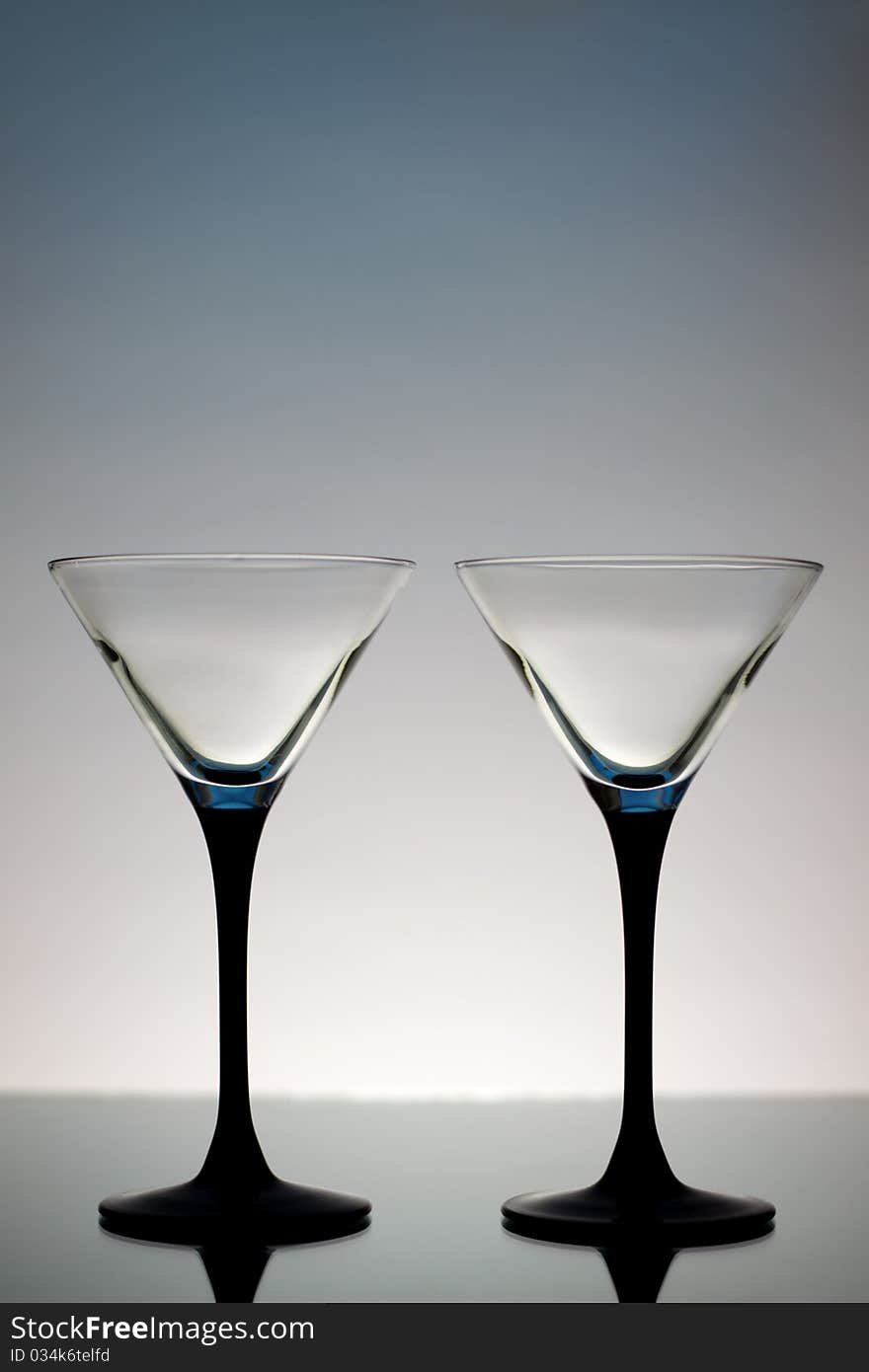 Two Martini Glasses on a gray background