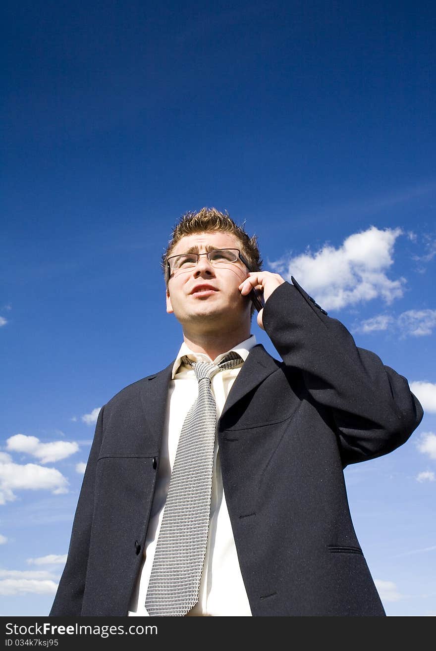 A businessman dressed in a smart suit standing on grass