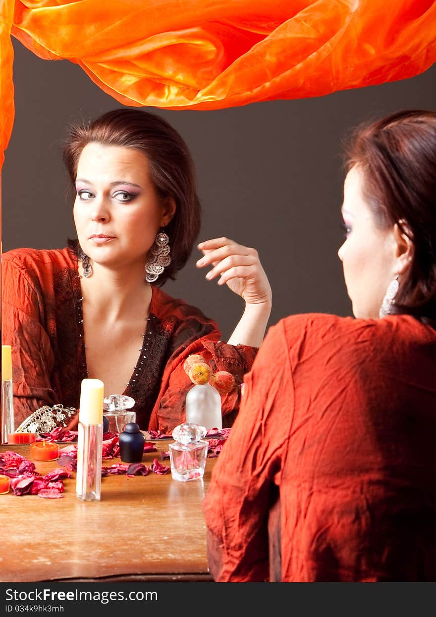 Beautiful Young Woman Looking At Mirror