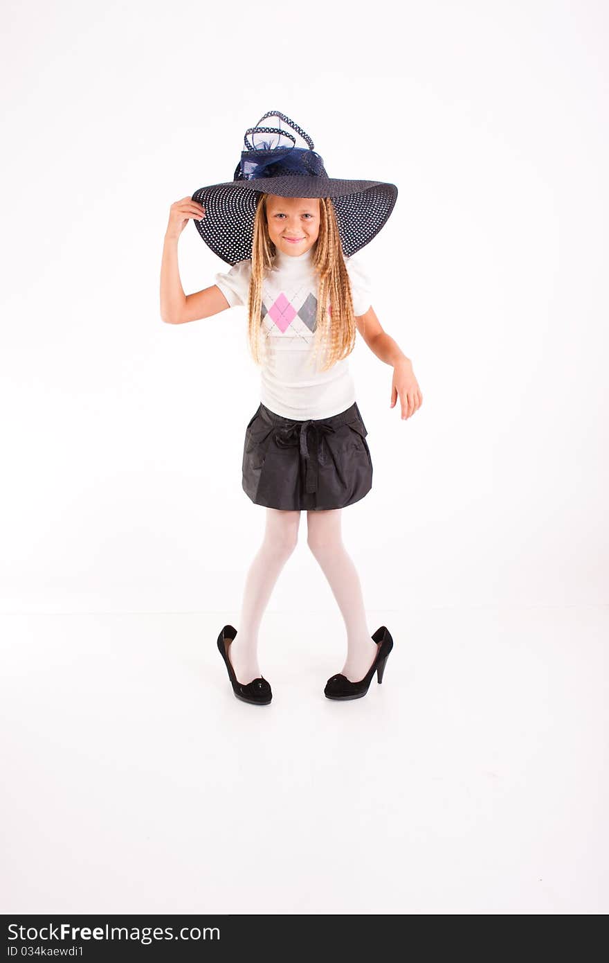 Funny girl in big hat and mum's shoes, isolated on white. Funny girl in big hat and mum's shoes, isolated on white