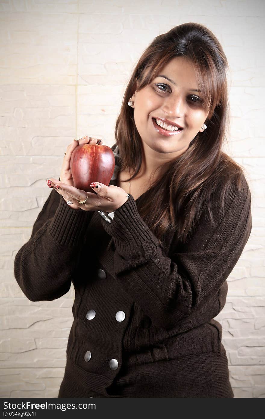 Beautiful girl holding ripe apple in her hand. Beautiful girl holding ripe apple in her hand.