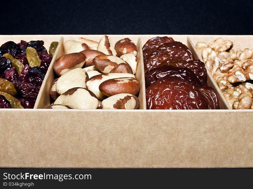 A close up of a box of dried fruit and nuts