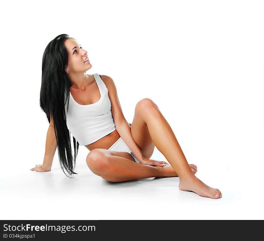 Beautiful young girl sit. Isolaed on a white background. Beautiful young girl sit. Isolaed on a white background