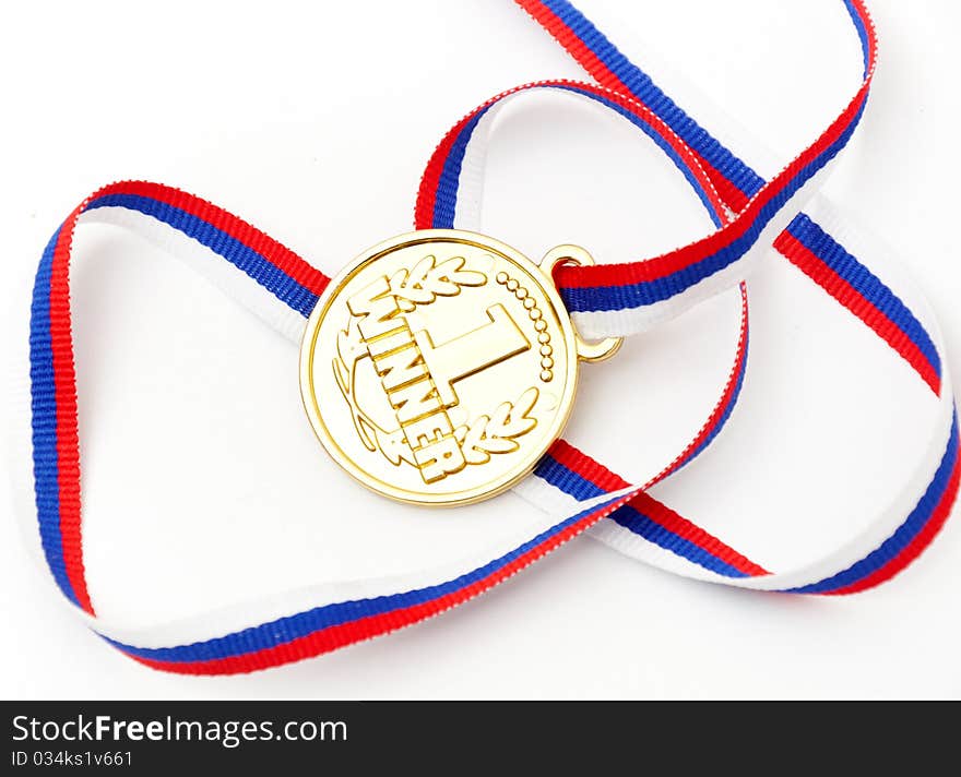 Golden medal and ribbon isolated on white background. Golden medal and ribbon isolated on white background