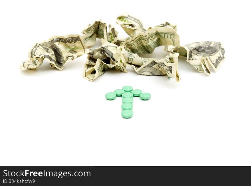 Crumpled american money and pills isolated on white