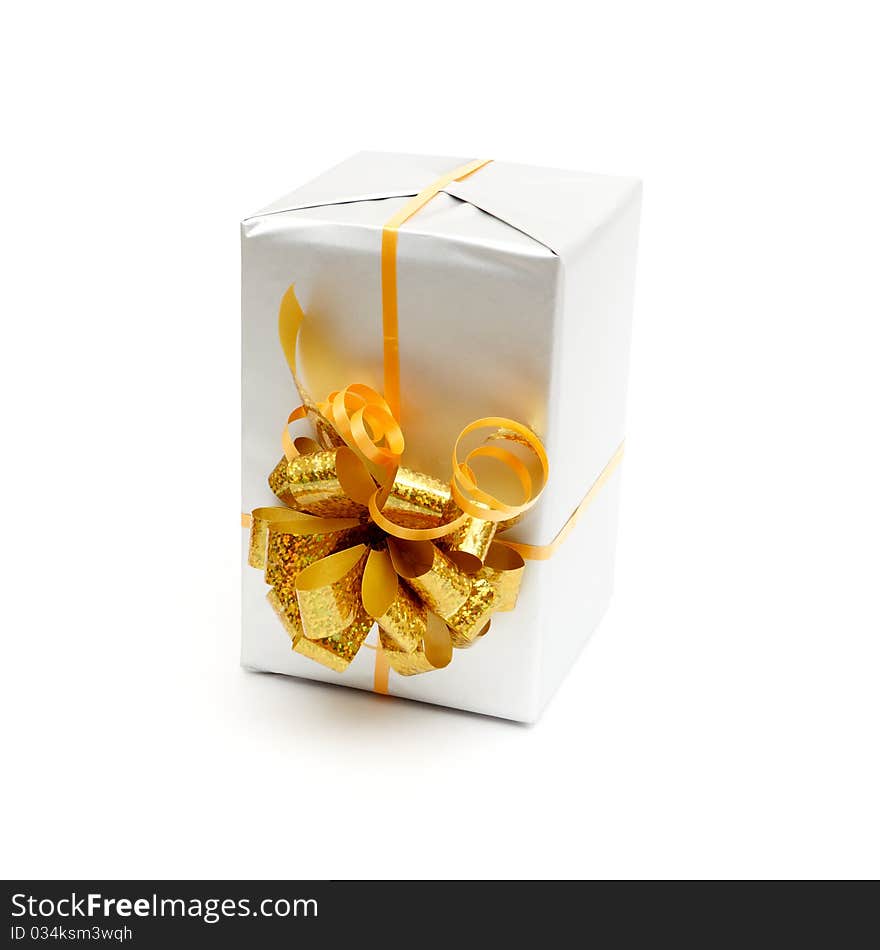 White gift with gold bow isolated on white background