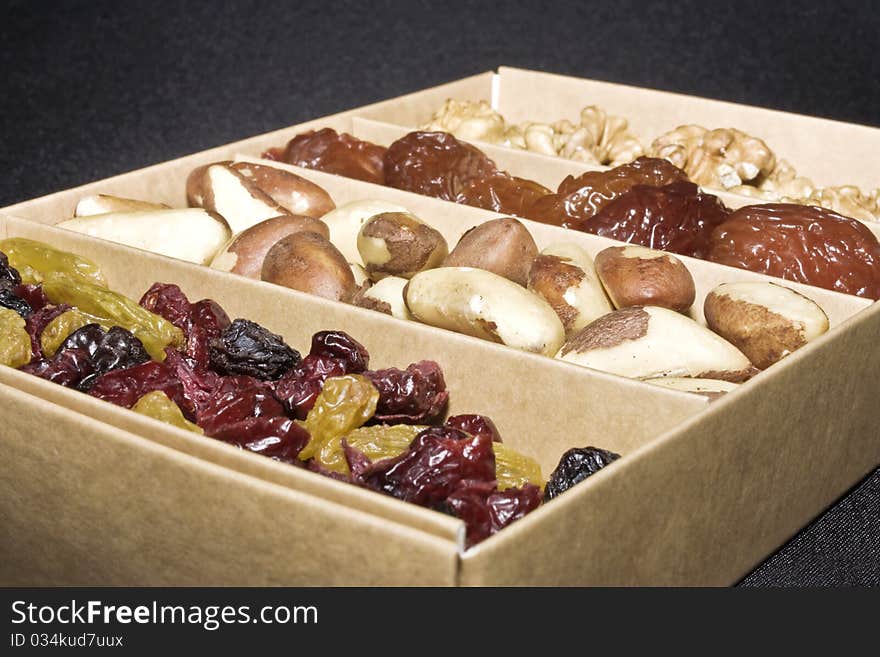 A close up of a box of dried fruit and nuts. A close up of a box of dried fruit and nuts