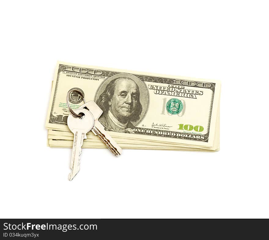 Keys and stack of dollars isolated on a white background