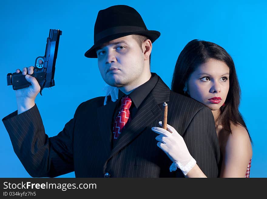 Young couple dressed elegant playing as bonnie and clyde