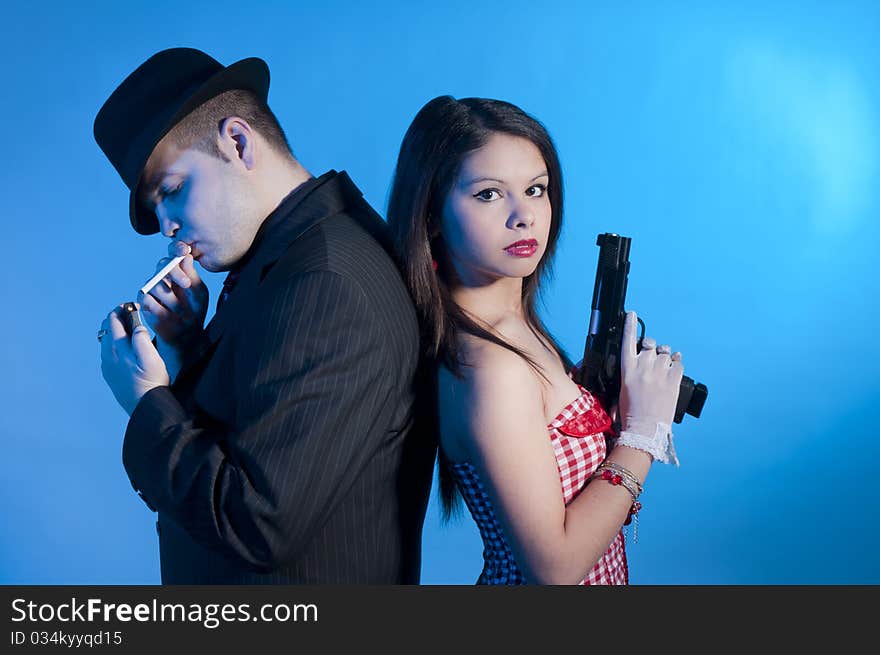 Young couple dressed elegant playing as bonnie and clyde