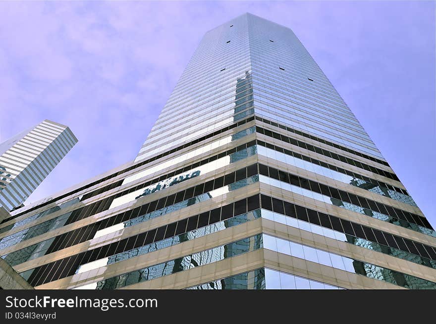 Modern buildings in Hongkong, under blue sky, with glass external and reflection, means business developing and urban environment. Modern buildings in Hongkong, under blue sky, with glass external and reflection, means business developing and urban environment.