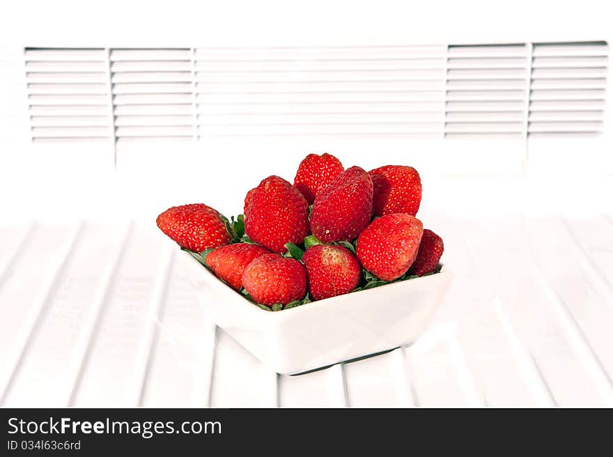 Fresh strawberry in white bowl isolated on white. Fresh strawberry in white bowl isolated on white