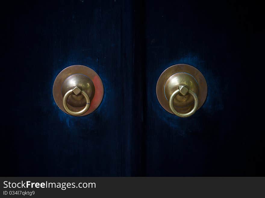 Historical Copper Handles on Blue Doors