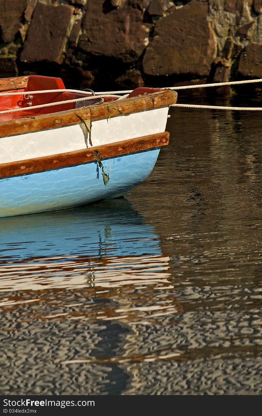 Blue and white boat reflection on water