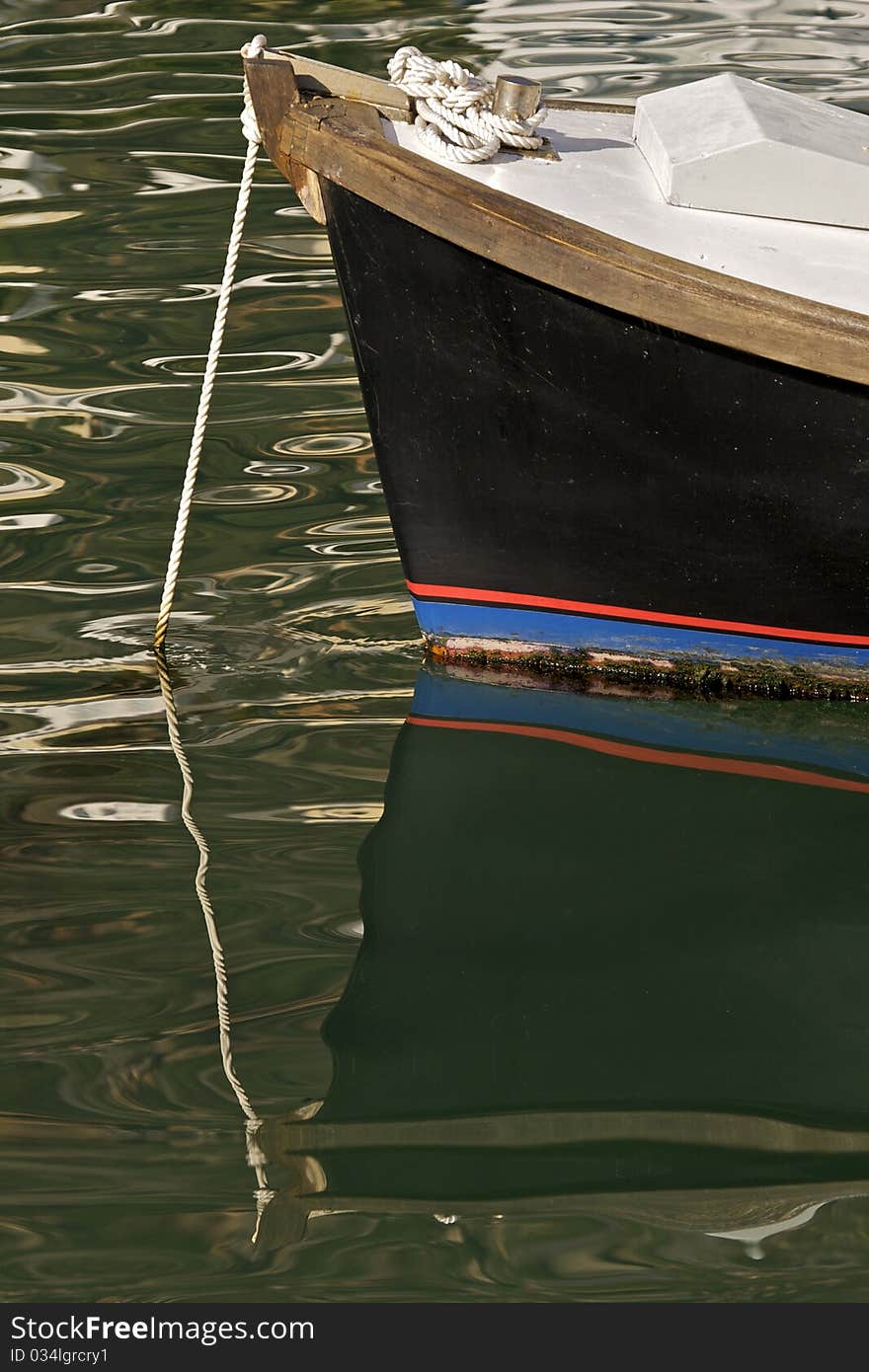 Fishing boat reflection on water