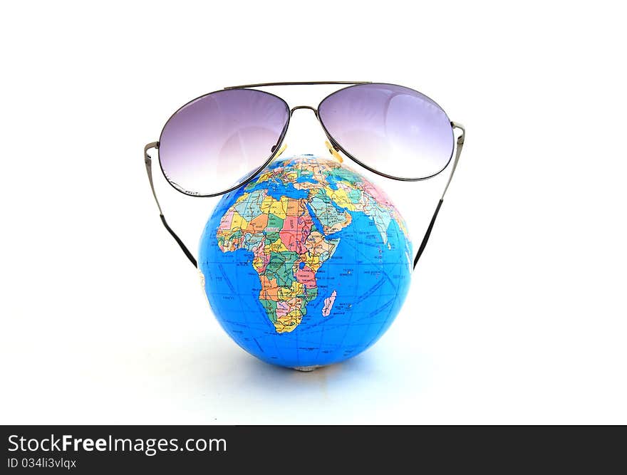 Globe with sunglasses isolated on the white