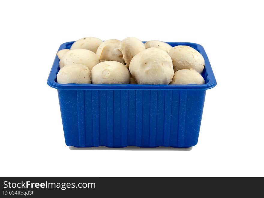 Fresh mushrooms in blue plastic box, isolated on white.Clipping paths of mushrooms and shadow on separete included.Easy work with. Fresh mushrooms in blue plastic box, isolated on white.Clipping paths of mushrooms and shadow on separete included.Easy work with.