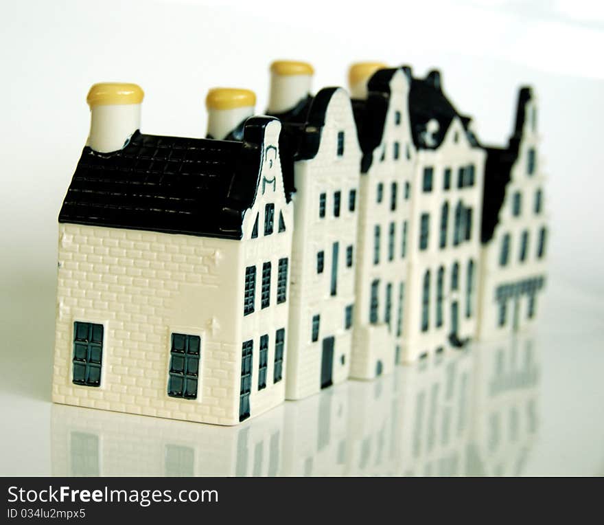 Row of five Dutch ceramic spirit bottles in the form of canalside homes, showing controlled depth of field. Row of five Dutch ceramic spirit bottles in the form of canalside homes, showing controlled depth of field