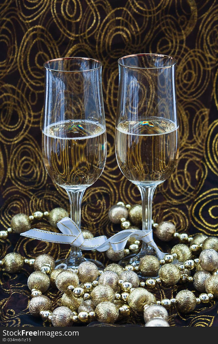 Two glass of champagne united with decorative tape