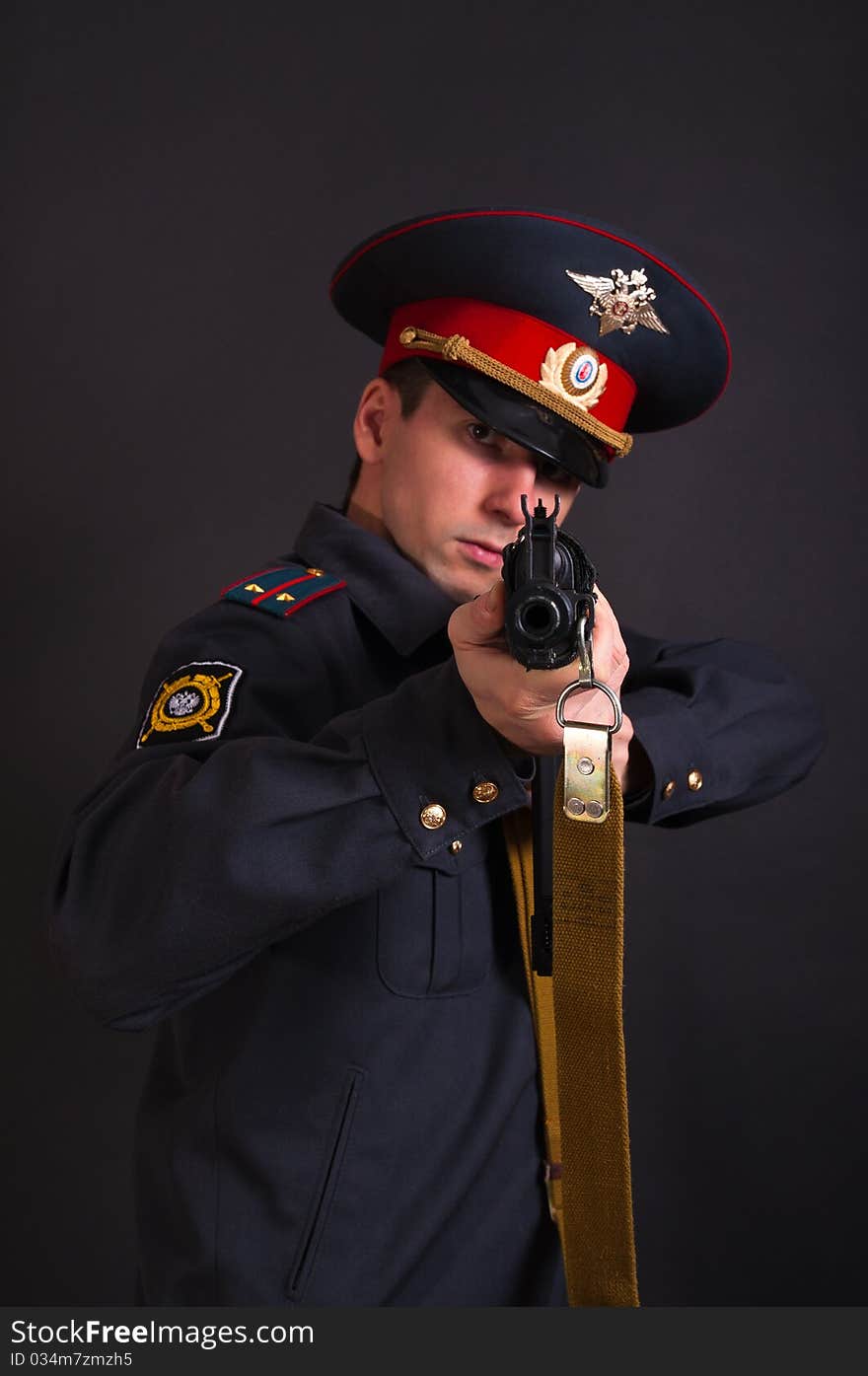 Police officer in uniform with a gun