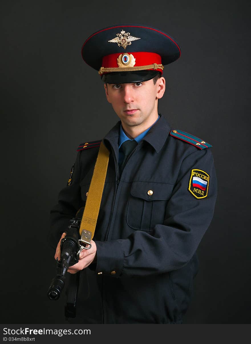 Police officer in uniform with a gun. Police officer in uniform with a gun