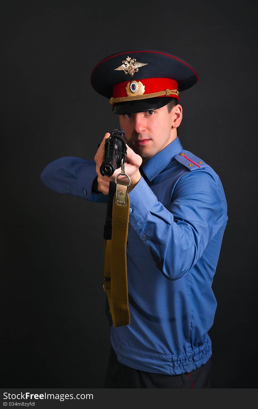 Police officer in uniform with machine gun AK-47