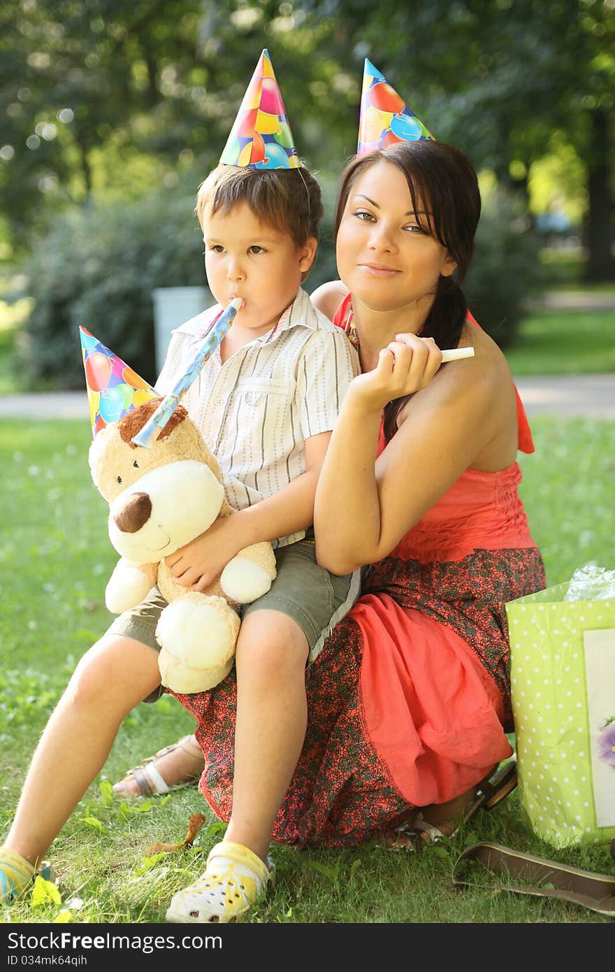 Young beautiful mother with son on birthday