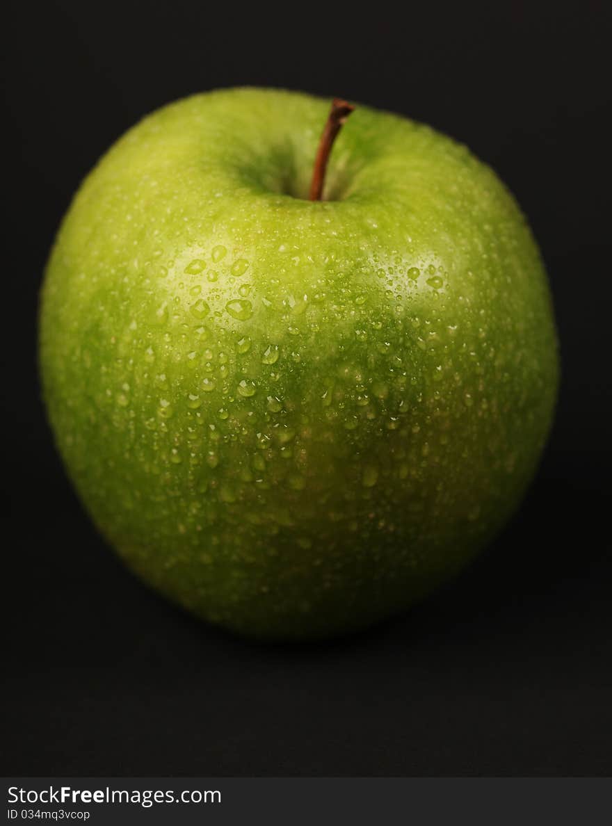 Fresh green apple on black