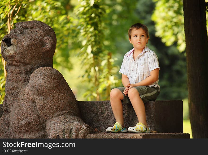 Little boy sitting in park. Little boy sitting in park