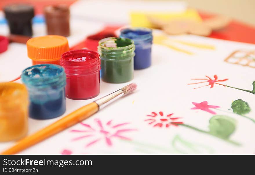 Painted flowers and bottles of gouache. Painted flowers and bottles of gouache