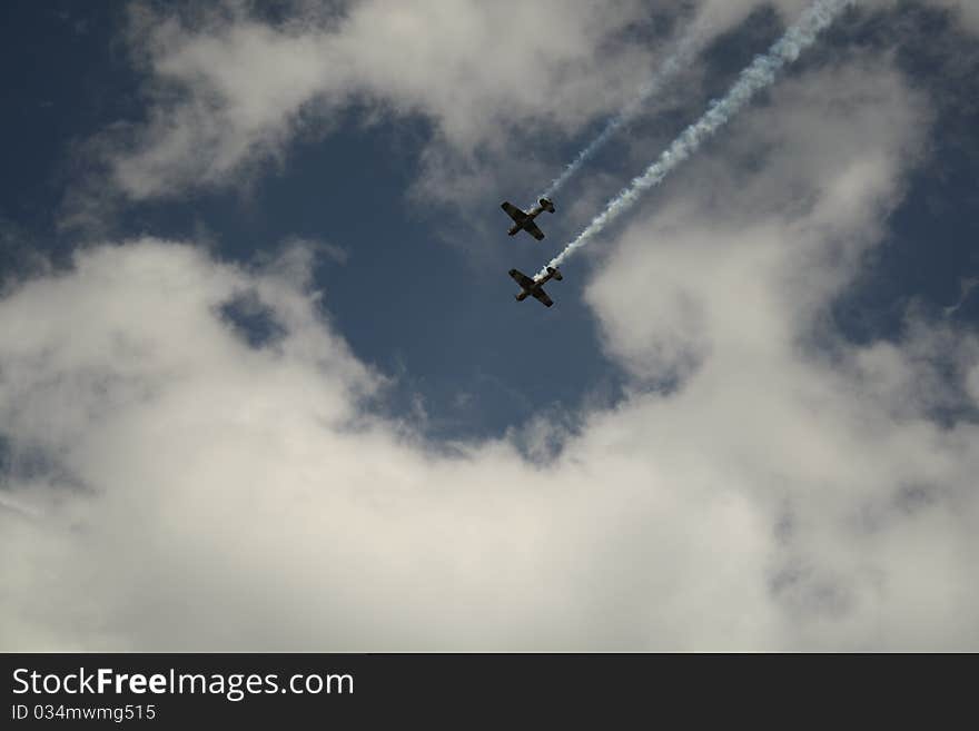 Two small airplanes flying together trough clouds. Two small airplanes flying together trough clouds