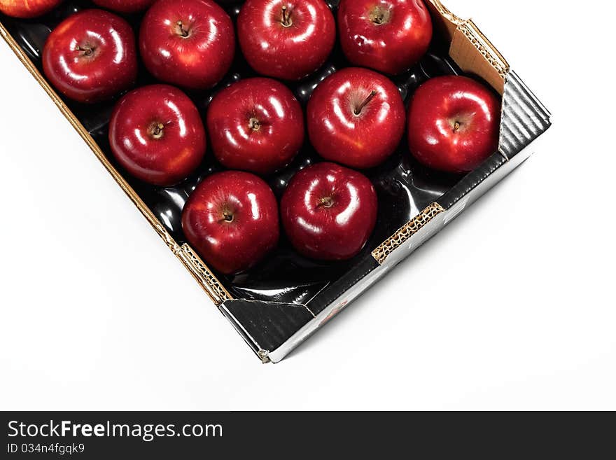 Box of fresh red apples isolated on white background