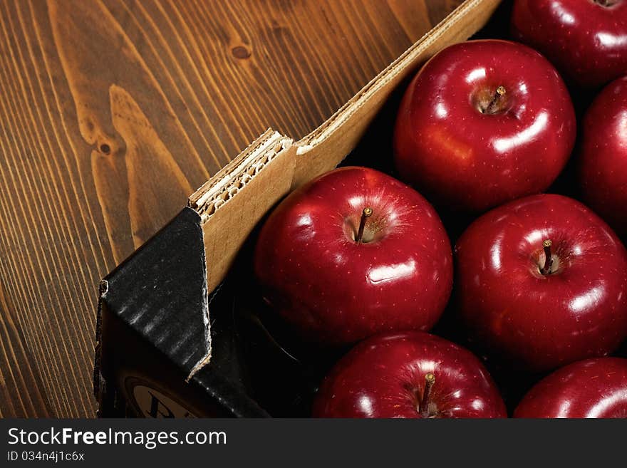 Close-up of Box of fresh apples on wood desk