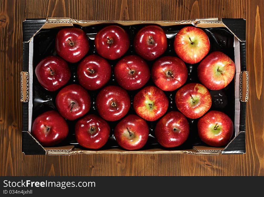 Box of fresh apples on wood desk