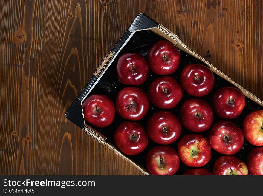 Close-up of Box of fresh apples on wood desk