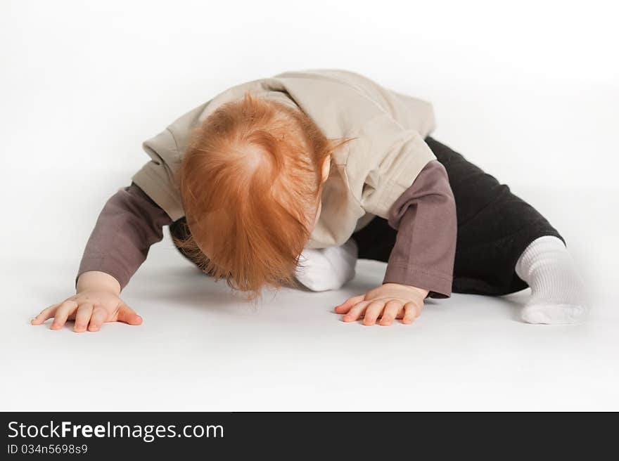 Small boy laying on a white floor. Small boy laying on a white floor.