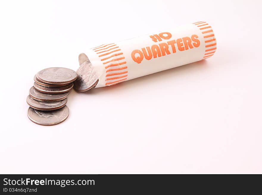 A $10 roll of U.S. Quarters spilling out. A $10 roll of U.S. Quarters spilling out.