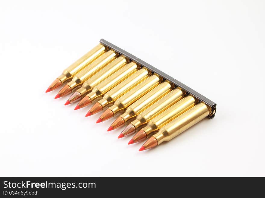 A row of .223 bullets on a stripper clip. A row of .223 bullets on a stripper clip.